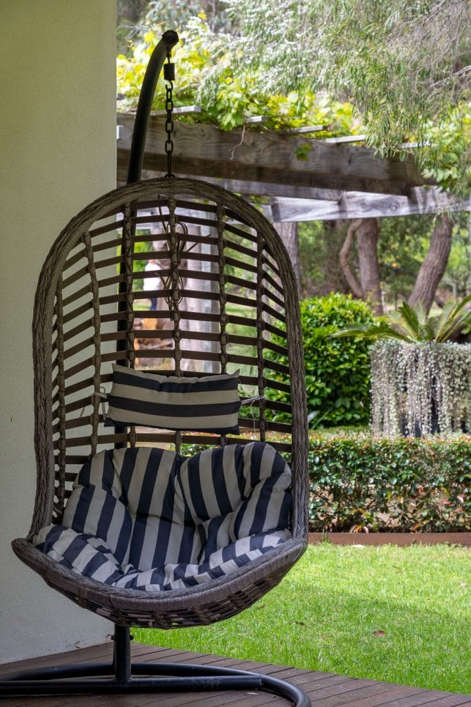 Photo of a hanging wicker chair in the garden