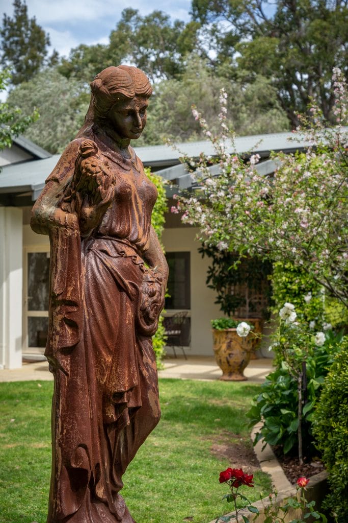 Photo of a statue of a lady in the garden