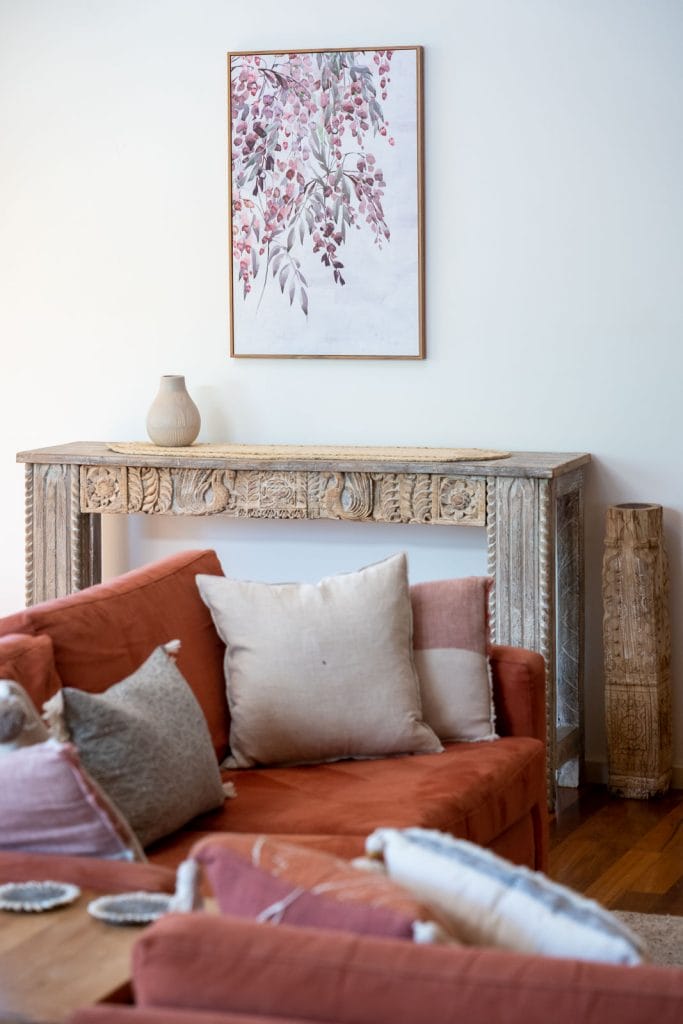 Photo of an orange sofa with background artwork